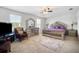 Large main bedroom with plush bed, dresser, and sitting area at 35716 Hillbrook Ave, Zephyrhills, FL 33541