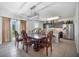 Dining room with a large wooden table and chairs, adjacent to the kitchen at 35716 Hillbrook Ave, Zephyrhills, FL 33541