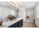 Double vanity bathroom with granite countertops and a large walk-in shower at 35716 Hillbrook Ave, Zephyrhills, FL 33541