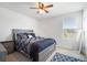 Bright bedroom with a double bed, nightstand and ceiling fan at 35716 Hillbrook Ave, Zephyrhills, FL 33541