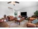Bright living room with comfortable leather sofas and a large flat-screen TV at 35716 Hillbrook Ave, Zephyrhills, FL 33541