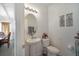 Clean and updated half bathroom with white pedestal sink and toilet at 35716 Hillbrook Ave, Zephyrhills, FL 33541