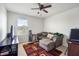 Cozy bedroom featuring a sectional sofa and a large TV at 35716 Hillbrook Ave, Zephyrhills, FL 33541