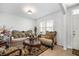 Living room with ornate furniture, a large TV and decorative accents at 35716 Hillbrook Ave, Zephyrhills, FL 33541