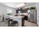 Modern kitchen with dark cabinets, stainless steel appliances, and an island at 35716 Hillbrook Ave, Zephyrhills, FL 33541