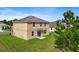 Two-story house, rear view, with grassy backyard at 35716 Hillbrook Ave, Zephyrhills, FL 33541