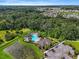 Aerial view of community pool, clubhouse, and surrounding landscape at 35716 Hillbrook Ave, Zephyrhills, FL 33541