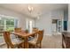 Dining area with wooden table, chairs, and access to the entryway at 9911 Golden Loop, New Port Richey, FL 34654