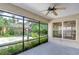 Spacious screened-in porch with tile flooring and ceiling fan at 10922 Brucehaven Dr, Riverview, FL 33578