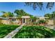 Attractive ranch home with landscaped lawn and walkway at 705 Bayshore Dr, Tarpon Springs, FL 34689