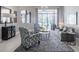 Comfortable living room with gray sofa and armchairs at 5014 Ruby Flats Dr, Wimauma, FL 33598