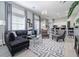 Open-concept living room with sectional sofa and large windows at 5014 Ruby Flats Dr, Wimauma, FL 33598