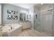 Elegant bathroom with soaking tub, walk-in shower, and modern vanity at 5014 Ruby Flats Dr, Wimauma, FL 33598