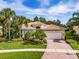 Single-Gathering home with lush landscaping and brick driveway at 5014 Ruby Flats Dr, Wimauma, FL 33598