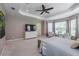 Spacious main bedroom with carpeted floor, ceiling fan and large windows at 5014 Ruby Flats Dr, Wimauma, FL 33598