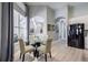 Cozy breakfast nook with glass-top table and comfortable seating near a large window at 5014 Ruby Flats Dr, Wimauma, FL 33598