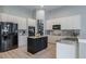 Modern kitchen with ample storage, granite counters and stainless steel appliances at 5014 Ruby Flats Dr, Wimauma, FL 33598