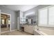 Bright bathroom with soaking tub, vanity, and access to bedroom at 5014 Ruby Flats Dr, Wimauma, FL 33598