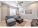 Cozy Gathering room featuring a comfortable sectional sofa and large window at 5014 Ruby Flats Dr, Wimauma, FL 33598