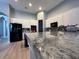 Granite countertop kitchen island with breakfast bar seating at 5014 Ruby Flats Dr, Wimauma, FL 33598