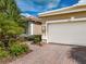 White garage door with brick paver driveway at 5014 Ruby Flats Dr, Wimauma, FL 33598