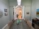 Formal dining room with gray table and view to living area at 5014 Ruby Flats Dr, Wimauma, FL 33598