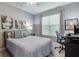 Comfortable bedroom with a workspace and large window at 5014 Ruby Flats Dr, Wimauma, FL 33598