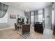 Spacious living room with hardwood floors, large windows, and comfortable seating at 5014 Ruby Flats Dr, Wimauma, FL 33598