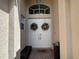 White double front doors with decorative wreaths at 5014 Ruby Flats Dr, Wimauma, FL 33598