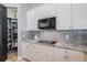 Stylish kitchen with white cabinets, granite countertops and modern appliances at 5014 Ruby Flats Dr, Wimauma, FL 33598