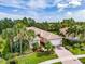 Aerial view of single-Gathering home with landscaped yard and brick driveway at 5014 Ruby Flats Dr, Wimauma, FL 33598