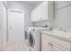 Convenient laundry room with washer, dryer, and extra storage at 5014 Ruby Flats Dr, Wimauma, FL 33598
