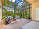 Relaxing screened patio with brick pavers and outdoor seating at 5014 Ruby Flats Dr, Wimauma, FL 33598
