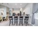 Modern kitchen with granite countertops, stainless steel appliances, and breakfast bar at 5014 Ruby Flats Dr, Wimauma, FL 33598