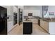 Open concept kitchen with white cabinets, granite counters and large pantry at 5014 Ruby Flats Dr, Wimauma, FL 33598