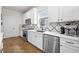 Clean kitchen with white cabinets, stainless steel appliances and patterned tile backsplash at 2953 Pier Pointe Ln, Clearwater, FL 33760