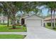 Single-story house with two-car garage and landscaping at 1331 Hickory Moss Pl, Trinity, FL 34655