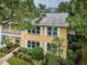 Charming condo with white shutters, balcony, and attractive landscaping at 2156 Masters Ct # 2156, Dunedin, FL 34698