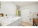 Functional laundry room with washer, dryer, and storage at 2419 Roxbury Cir, North Port, FL 34287