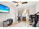 Home gym with exercise equipment and large TV at 2419 Roxbury Cir, North Port, FL 34287