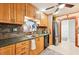 Modern kitchen with wood cabinets, stainless steel appliances and tile backsplash at 2419 Roxbury Cir, North Port, FL 34287