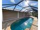 Screened pool with retractable shade covers at 132 Peckham Se St, Port Charlotte, FL 33952