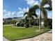 Single-story house with a metal roof, and landscaped yard at 132 Peckham Se St, Port Charlotte, FL 33952