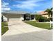 Single-story house with a metal roof, and landscaped yard at 132 Peckham Se St, Port Charlotte, FL 33952