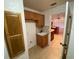 Laundry room with cabinets, sink, and view of kitchen at 132 Peckham Se St, Port Charlotte, FL 33952
