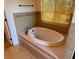 Oval bathtub with tile surround and large window at 132 Peckham Se St, Port Charlotte, FL 33952