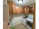 Bright laundry room with washer, dryer, and ample cabinetry at 132 Peckham Se St, Port Charlotte, FL 33952
