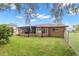 Spacious backyard with screened patio, lush lawn, and fenced perimeter at 8227 Rhanbuoy Rd, Spring Hill, FL 34606