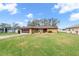 Single-story house with lawn and neighborhood view at 8227 Rhanbuoy Rd, Spring Hill, FL 34606