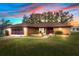 Single-story house with a brown roof and lush lawn at 8227 Rhanbuoy Rd, Spring Hill, FL 34606